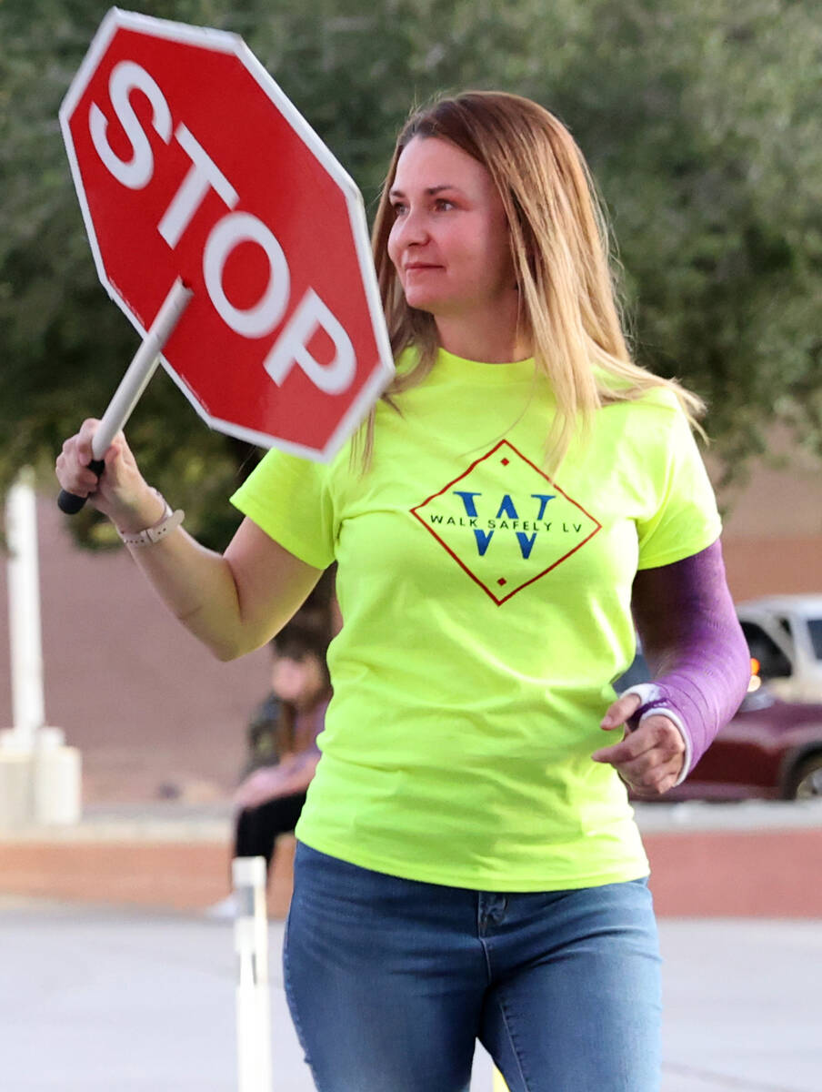 Ashley Brewer, a volunteer with Walk Safely LV, helps students get to school safely at Arbor Vi ...