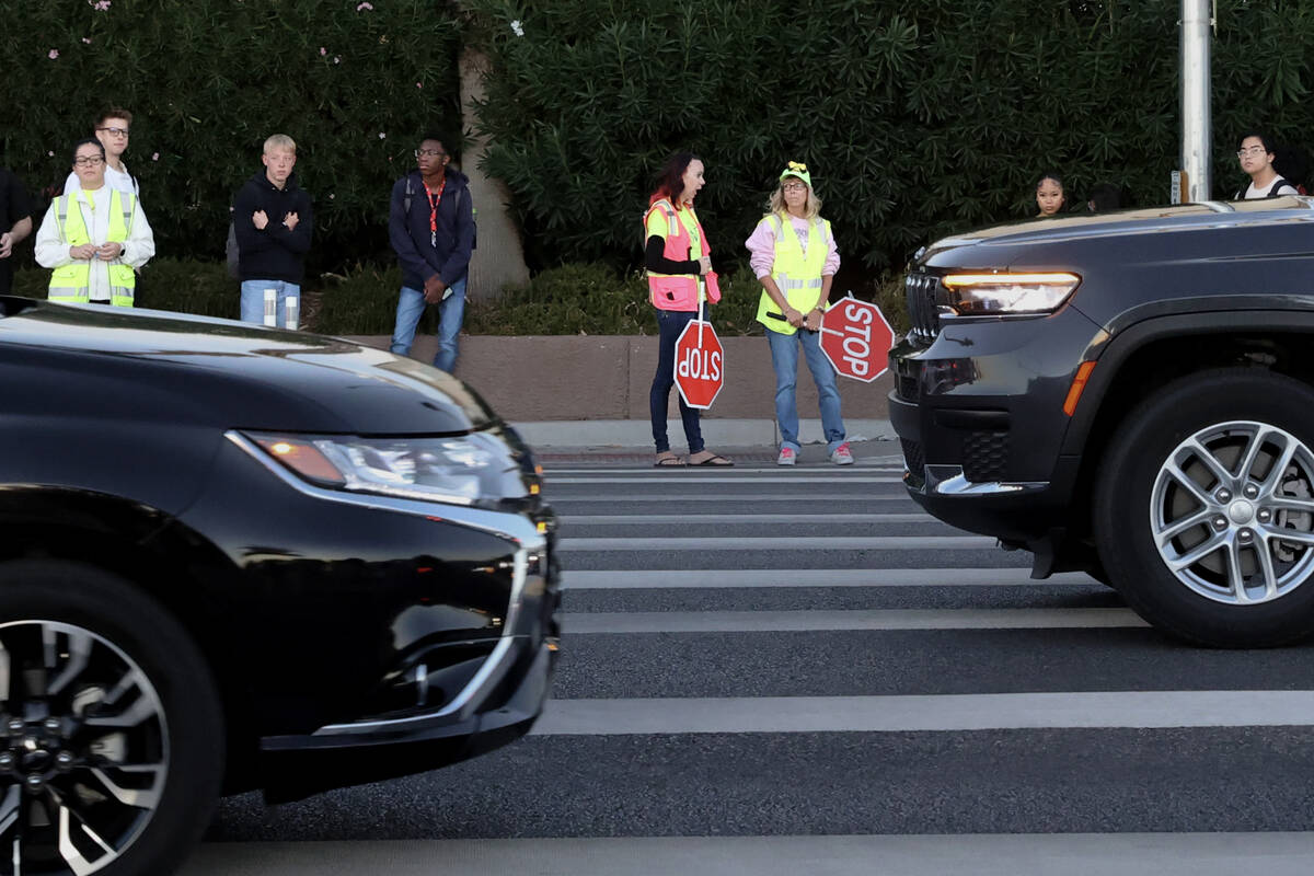 Bethany Limov, a volunteer with Walk Safely LV, left, talks with a paid crossing guard, who dec ...