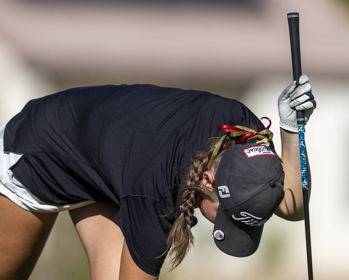 Faith Lutheran's Madison Perez has a few extra tees tucked into the back of her hat during ...