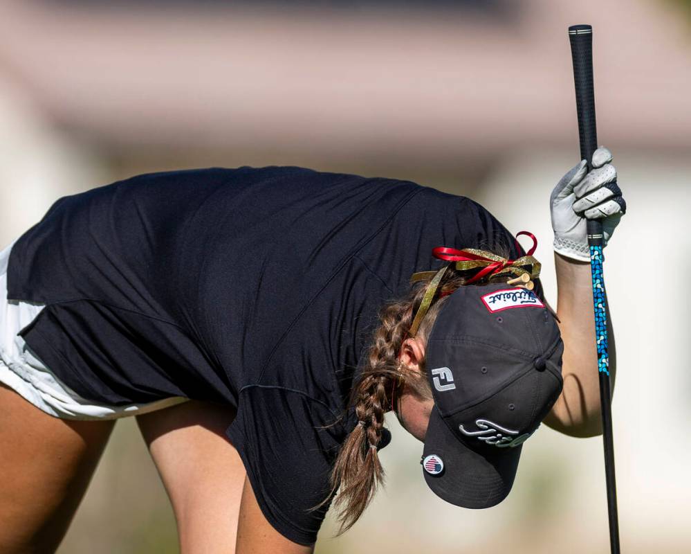 Faith Lutheran's Madison Perez has a few extra tees tucked into the back of her hat during ...