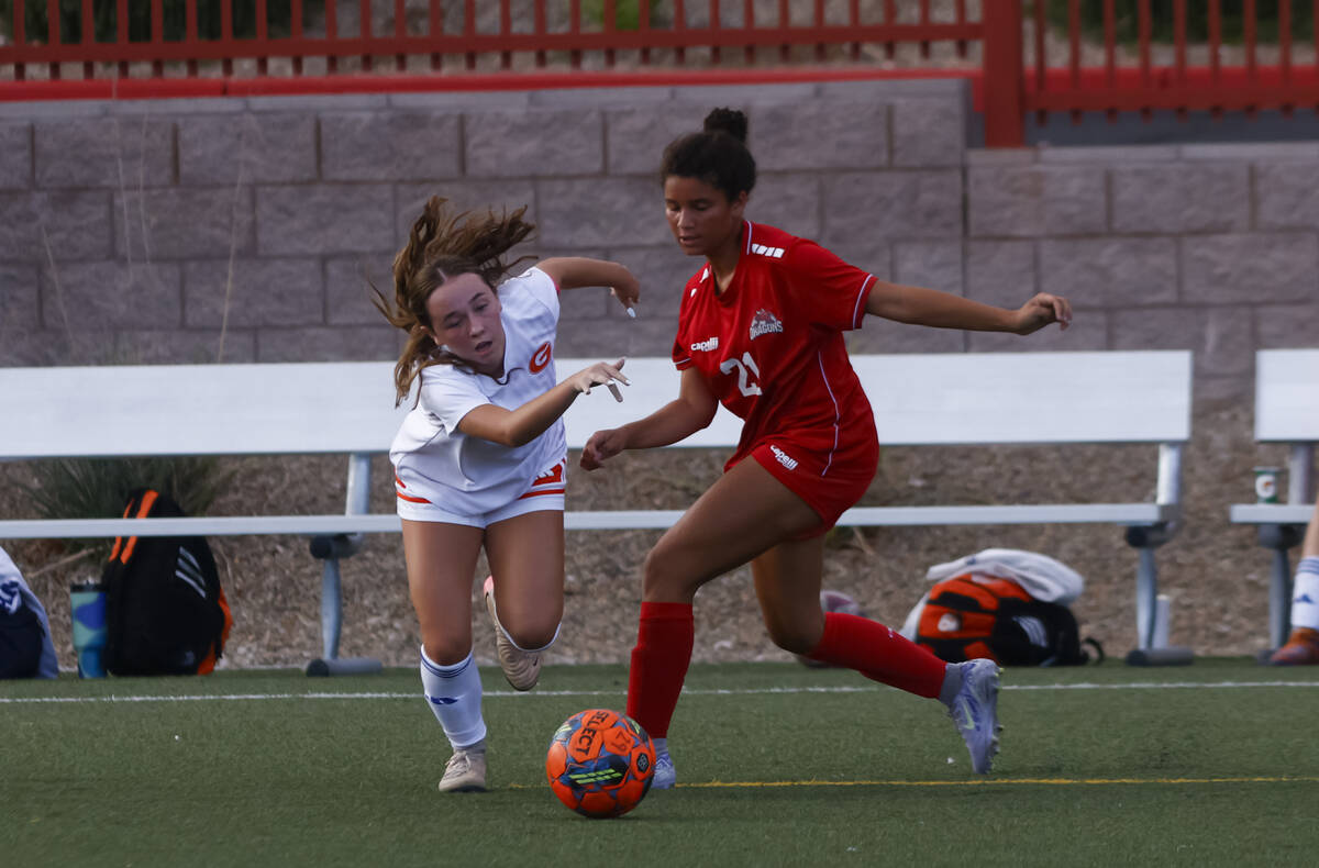 Bishop Gorman's Emma Flannery (3) and Doral Academy's Ari Smith (21) vie for the ball ...