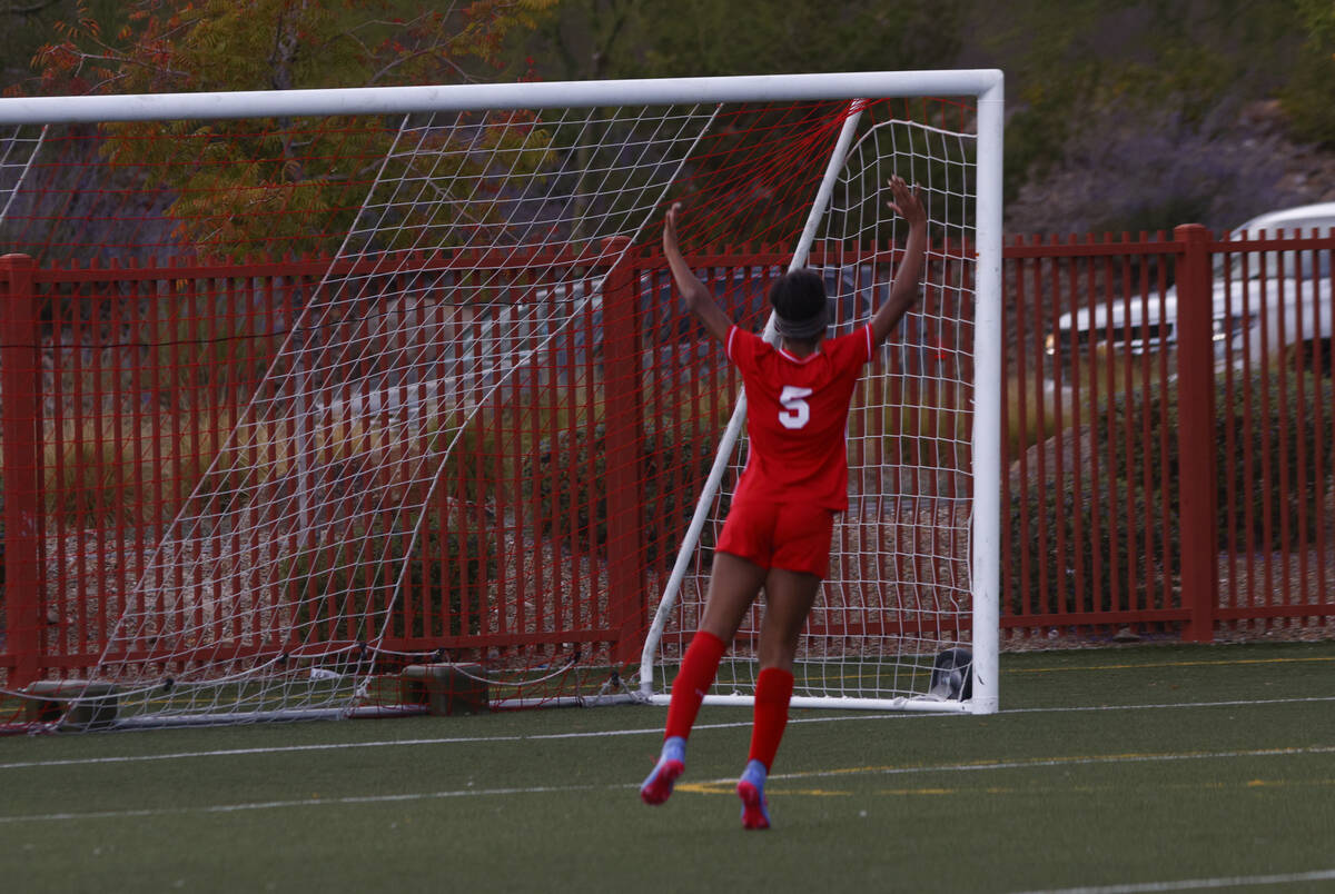 Doral Academy's Sanyi Thompson (5) celebrates a goal by Doral Academy's Sienna Turco, ...