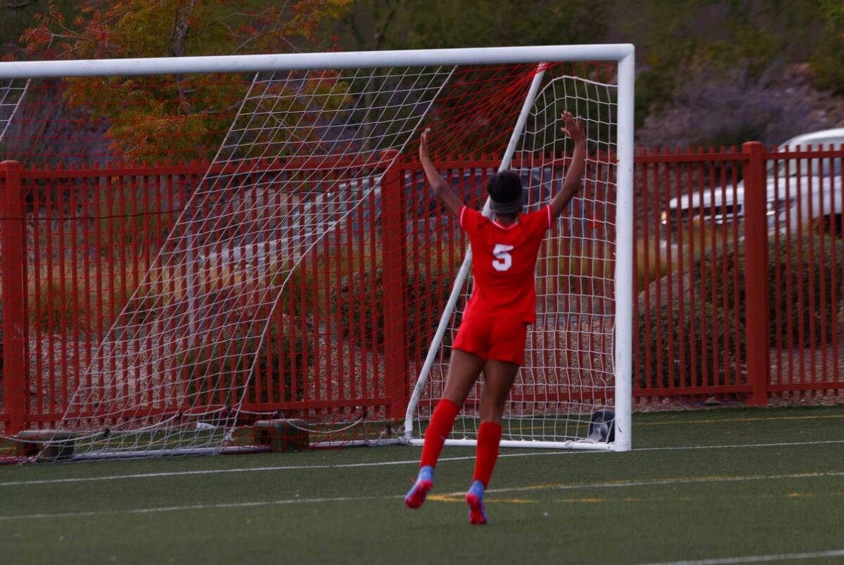 Doral Academy's Sanyi Thompson (5) celebrates a goal by Doral Academy's Sienna Turco, ...