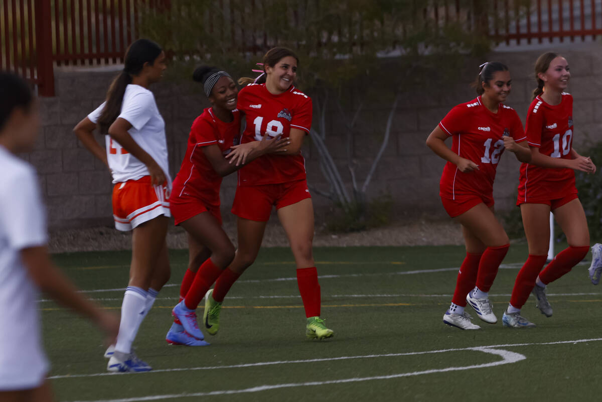Doral Academy's Sienna Turco (19) celebrates her goal with Sanyi Thompson, left, during a ...