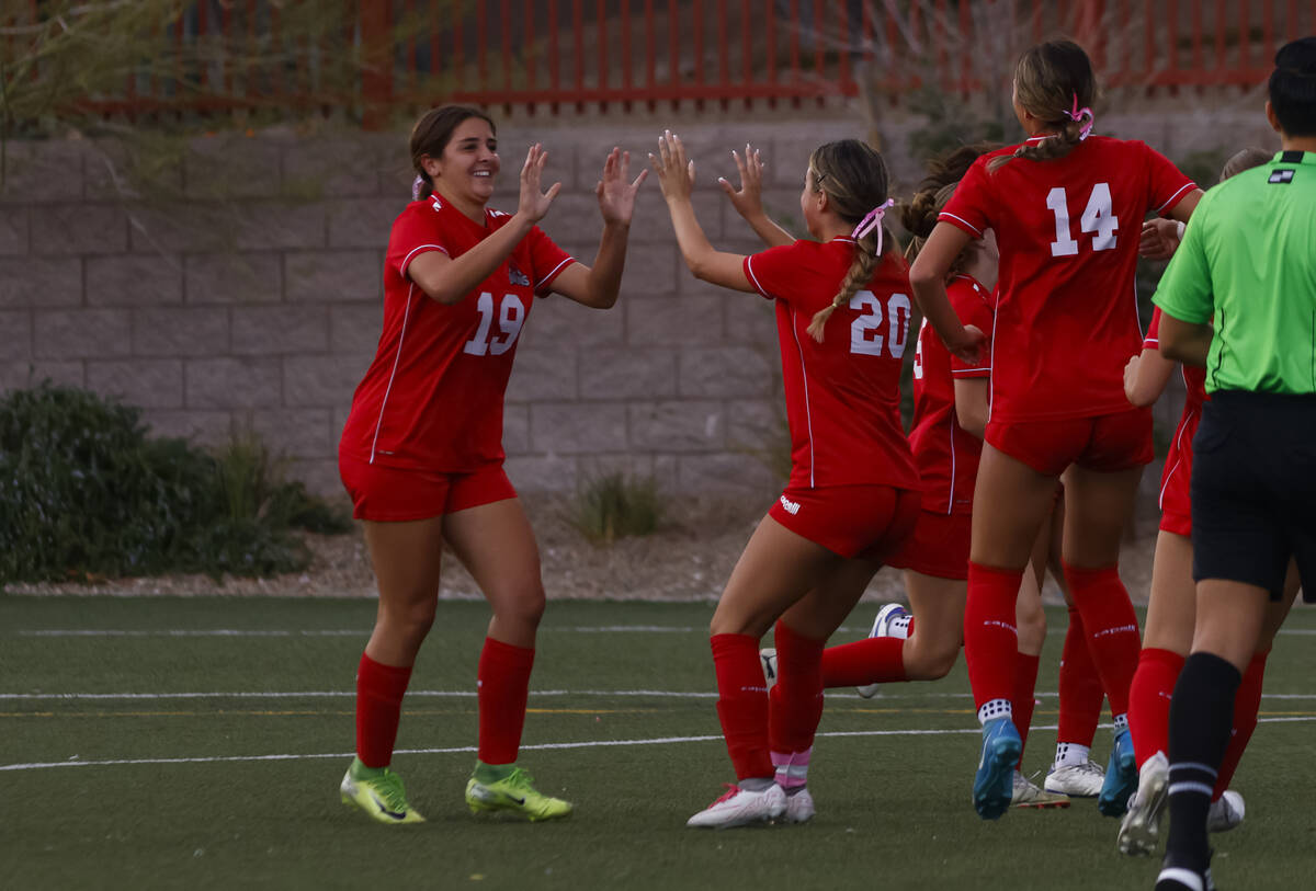 Doral Academy's Sienna Turco (19) celebrates her goal against Bishop Gorman with Doral Aca ...