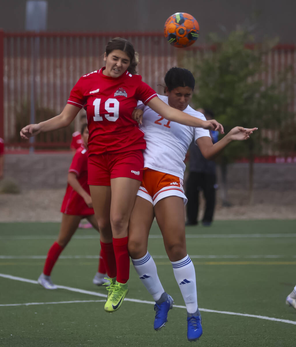 Doral Academy's Sienna Turco (19) heads the ball over Bishop Gorman's Laila Lazzara ( ...
