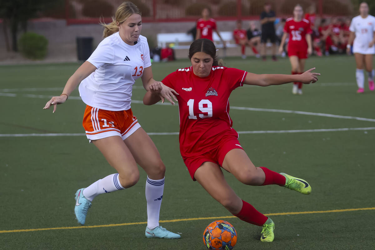 Doral Academy's Sienna Turco (19) looks to kick the ball as Bishop Gorman's Melina Du ...