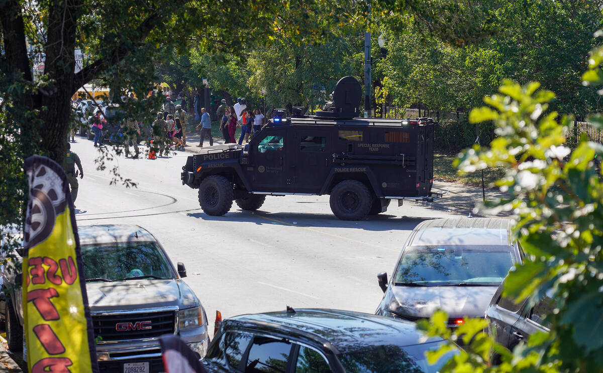 People protest as federal immigration agents conduct an investigation in the 3900 block of Sout ...