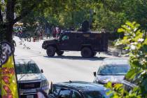People protest as federal immigration agents conduct an investigation in the 3900 block of Sout ...