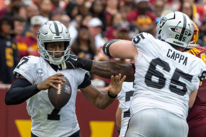Washington Commanders nose tackle Daron Payne (94) reaches into sack Raiders quarterback Geno S ...