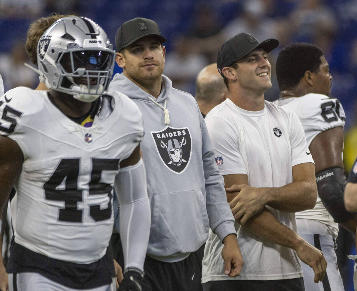 Raiders tight ends Michael Mayer, left center, and Brock Bowers, right center, watch as their t ...