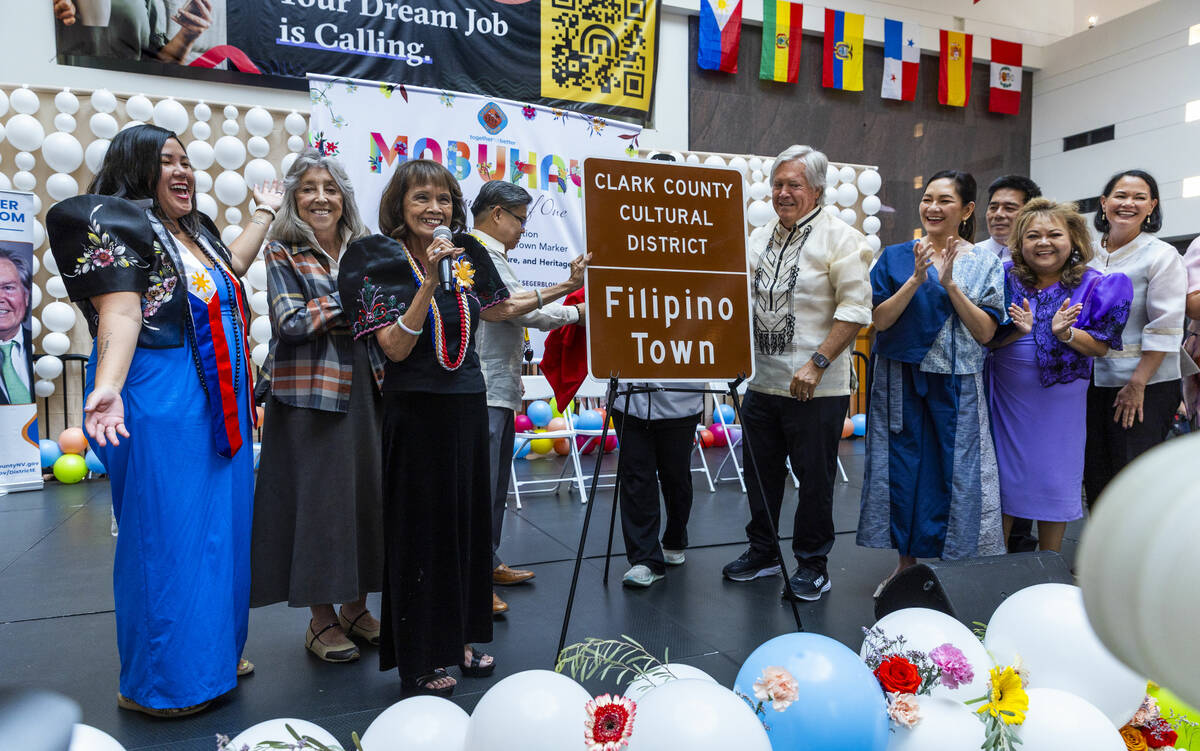 Rozita Lee and Clark County Commissioner Tick Segerblom with others help to unveil the new sign ...