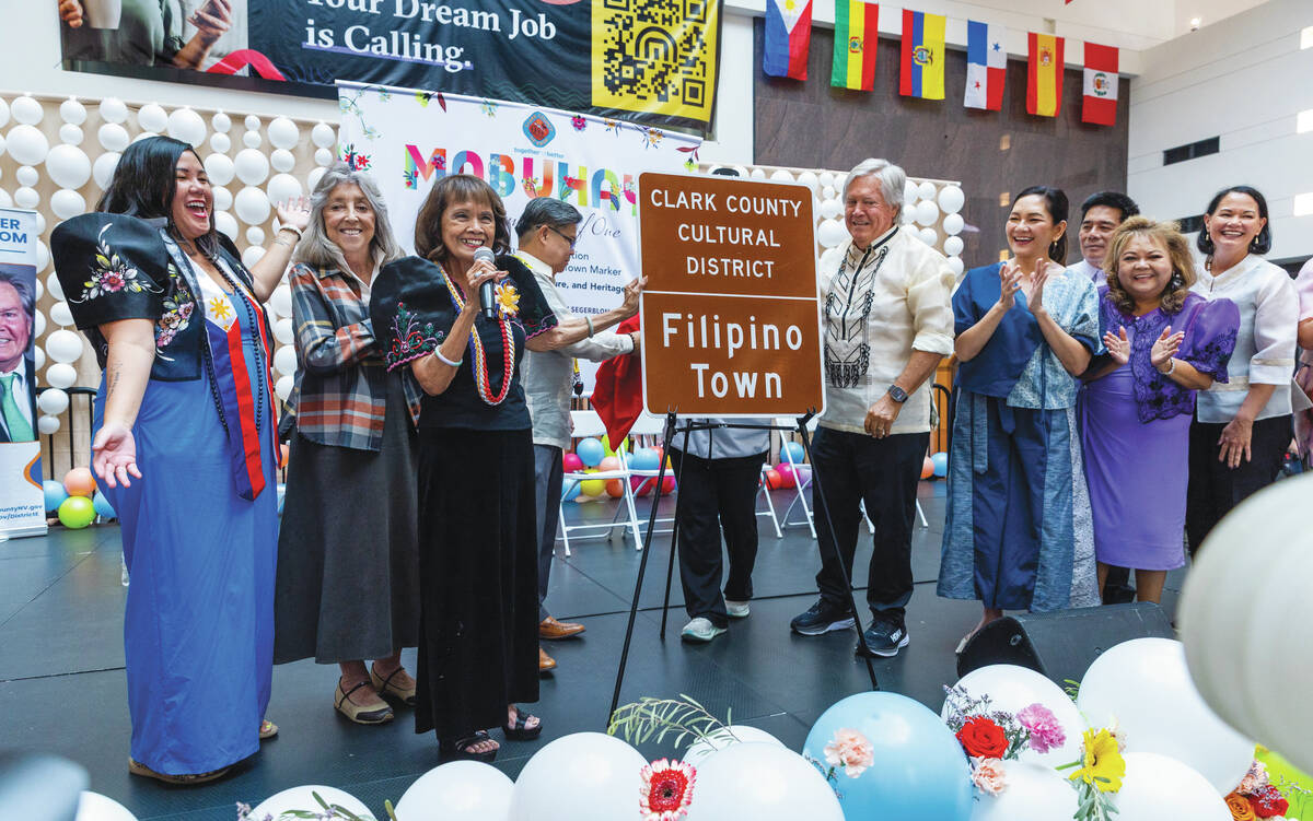 Rozita Lee and Clark County Commissioner Tick Segerblom with others help to unveil the new sign ...