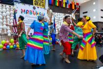 A Filipino dance troupe entertains the crowd as Clark County celebrates the sign unveiling for ...