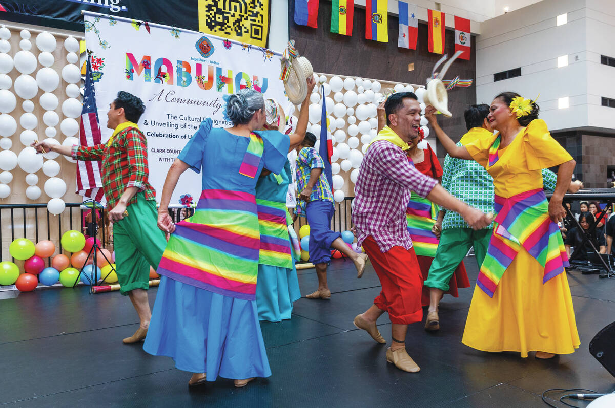 A Filipino dance troupe entertains the crowd as Clark County celebrates the sign unveiling for ...