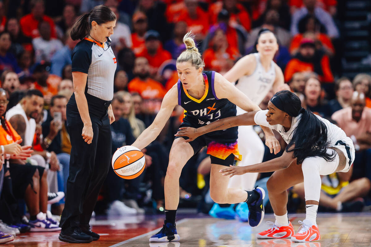 Aces guard Dana Evans (11) tries to swipe the ball from Phoenix Mercury guard Sami Whitcomb (33 ...
