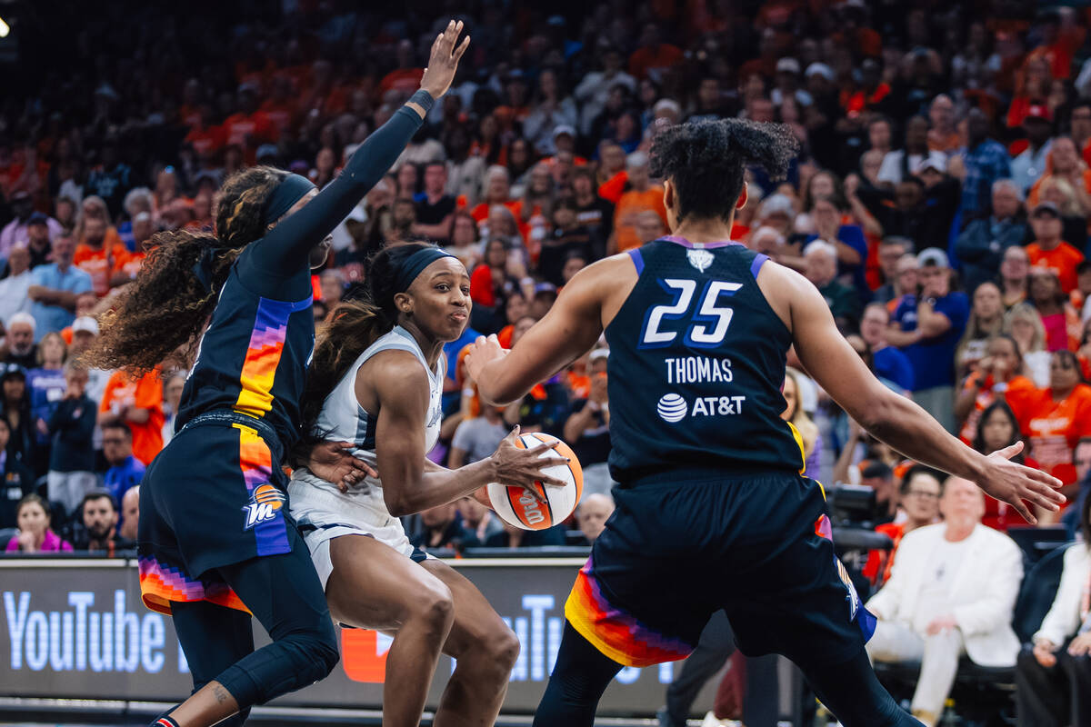 Aces guard Jackie Young (0) looks for an open teammate during game three of a WNBA finals match ...