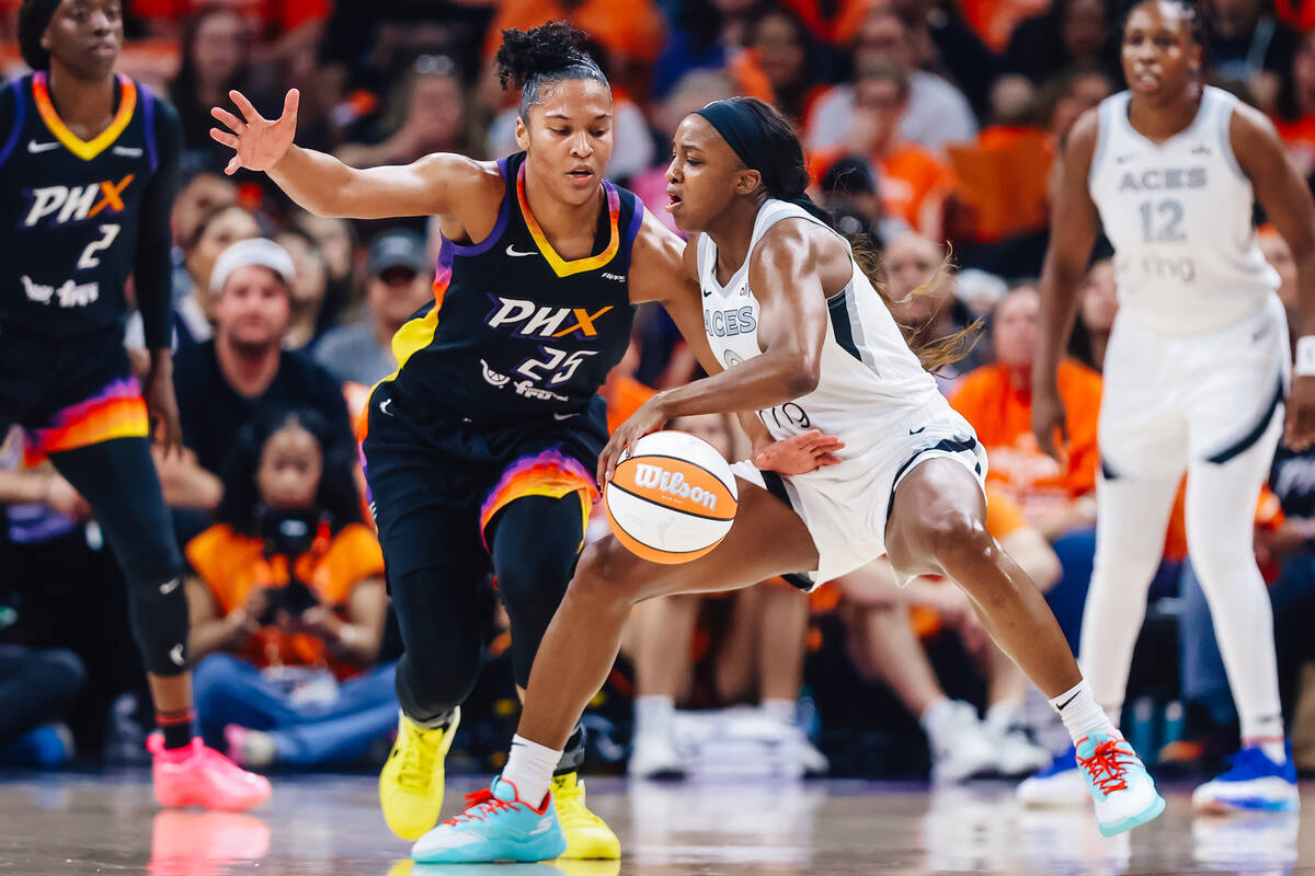 Aces guard Jackie Young (0) dribbles the ball against Phoenix Mercury forward Alyssa Thomas (25 ...
