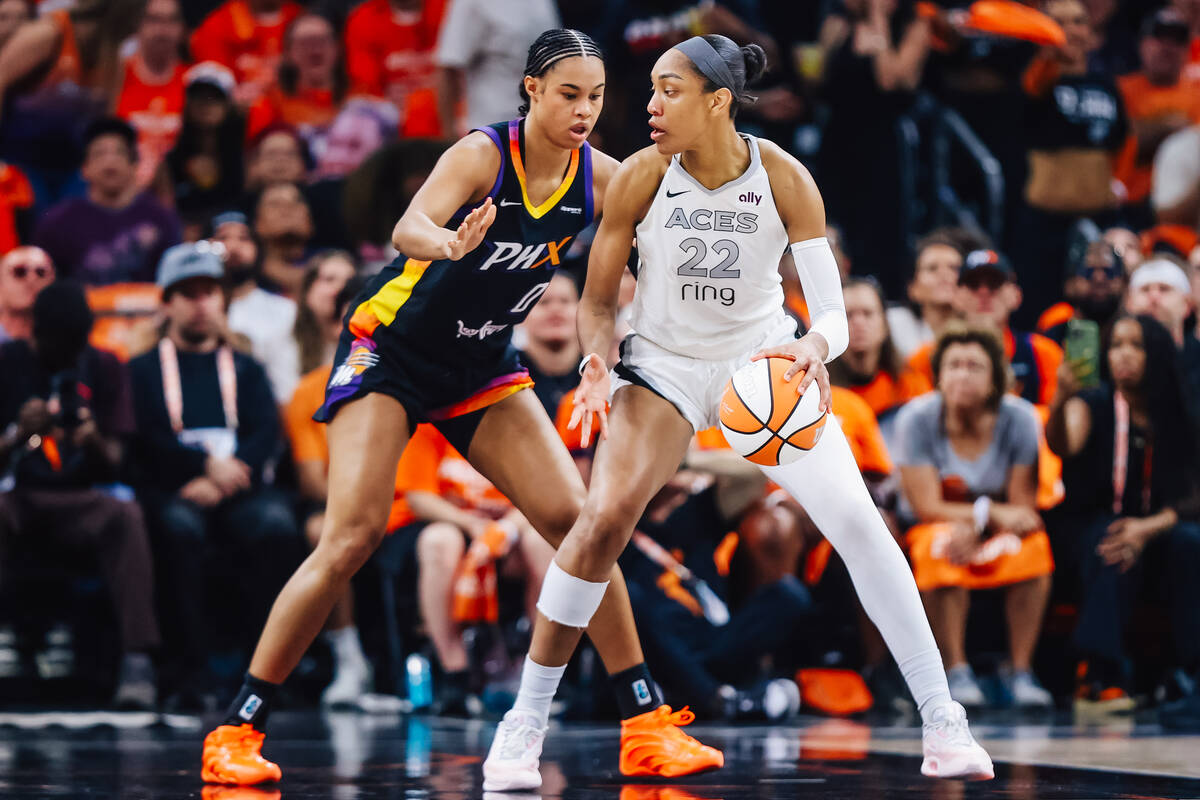 Aces center A'ja Wilson (22) dribbles the ball as Phoenix Mercury forward Satou Sabally (0 ...