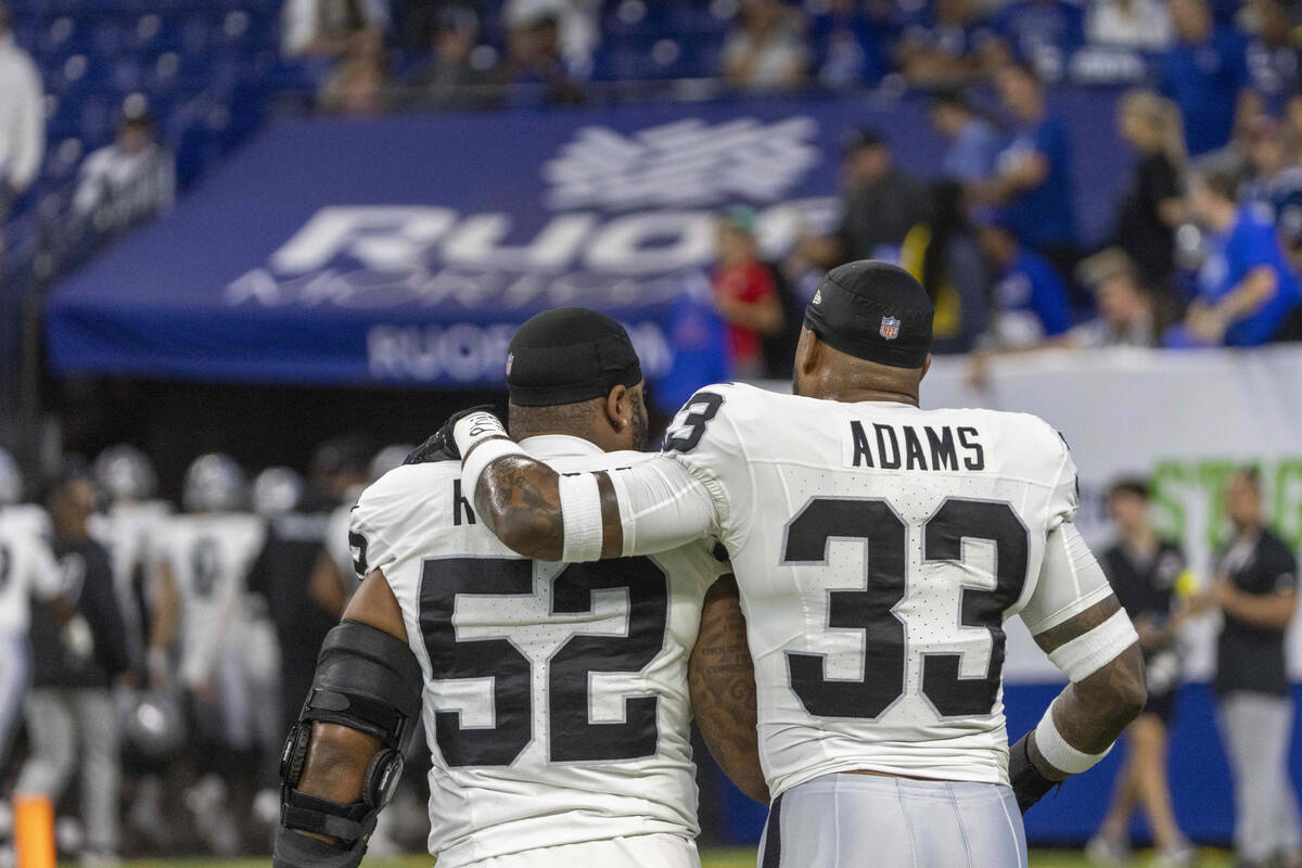 Raiders linebackers Elandon Roberts (52) and Jamal Adams (33) walk off the field together befor ...