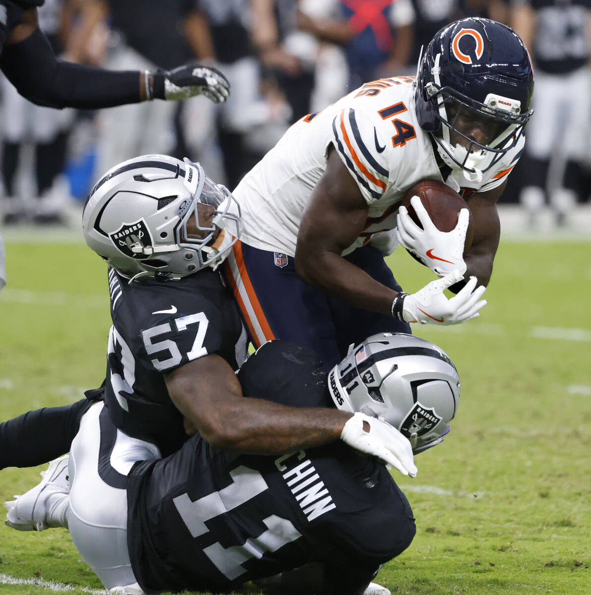 Chicago Bears wide receiver Olamide Zaccheaus (14) is taken down by Raiders linebacker Germaine ...