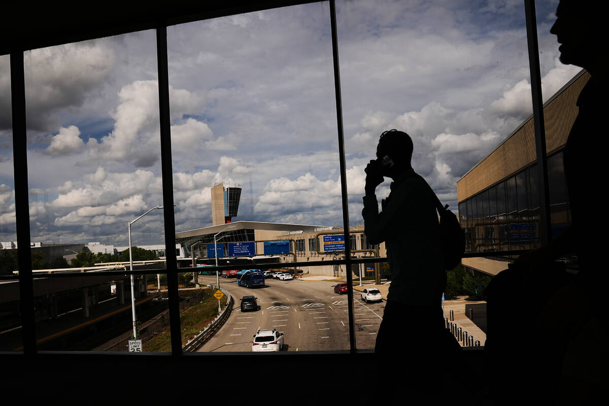 Passengers walk from a terminal at Philadelphia International Airport in Philadelphia, Tuesday, ...
