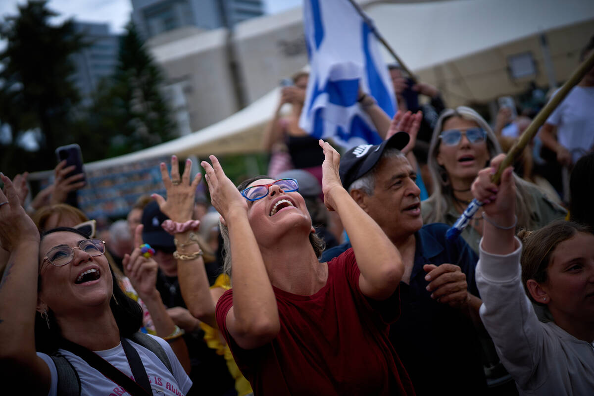 People react as they celebrate following the announcement that Israel and Hamas have agreed to ...