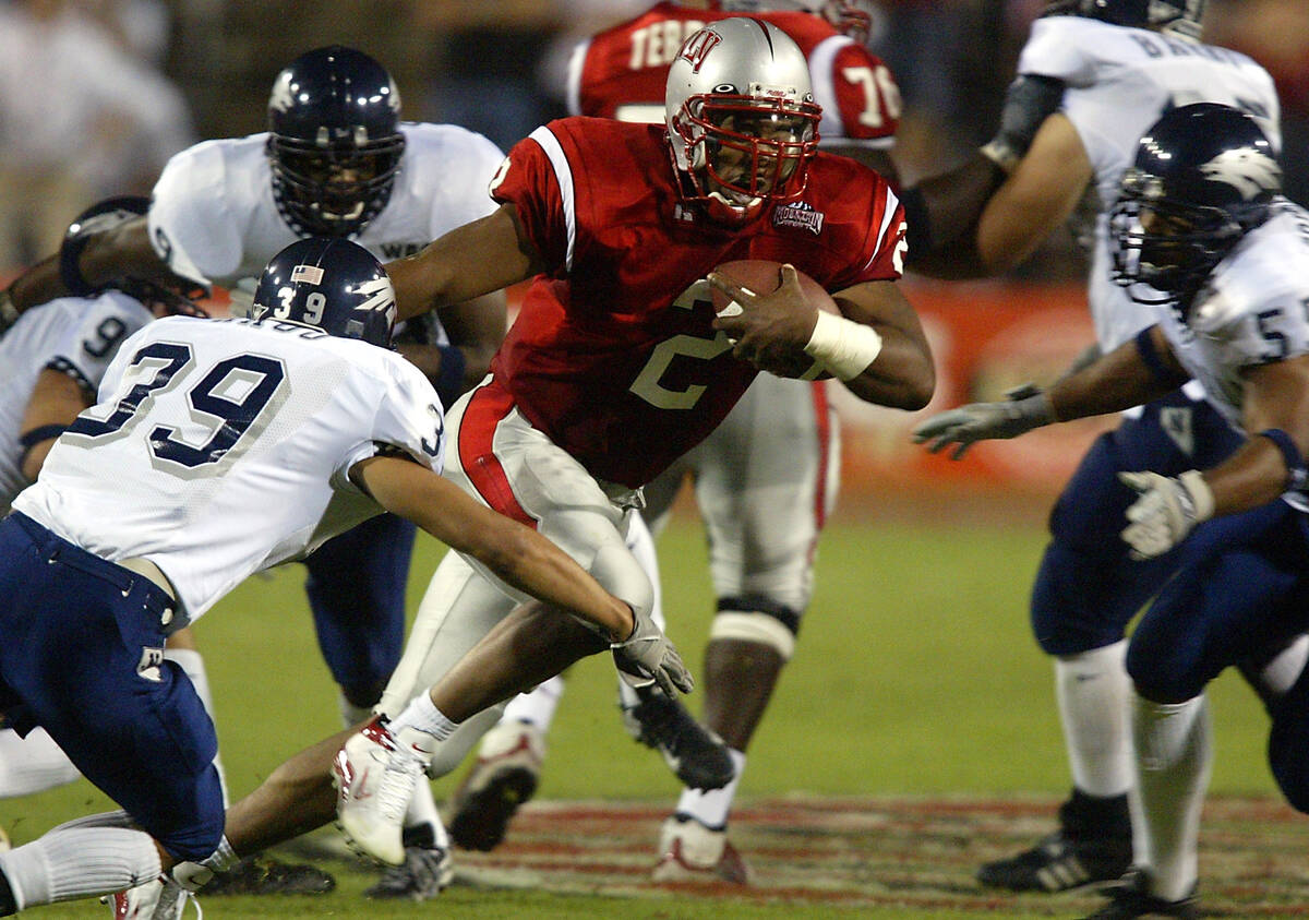 UNLV senior quarterback Jason Thomas (2) moves in traffic Oct. 5, 2002, against UNR at Sam Boyd ...