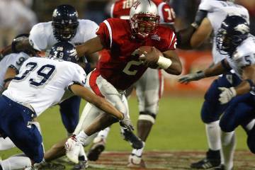 UNLV senior quarterback Jason Thomas (2) moves in traffic Oct. 5, 2002, against UNR at Sam Boyd ...