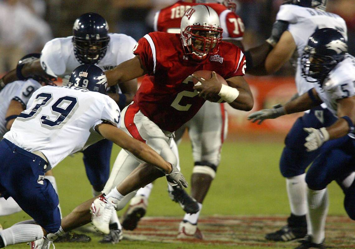 UNLV senior quarterback Jason Thomas (2) moves in traffic Oct. 5, 2002, against UNR at Sam Boyd ...