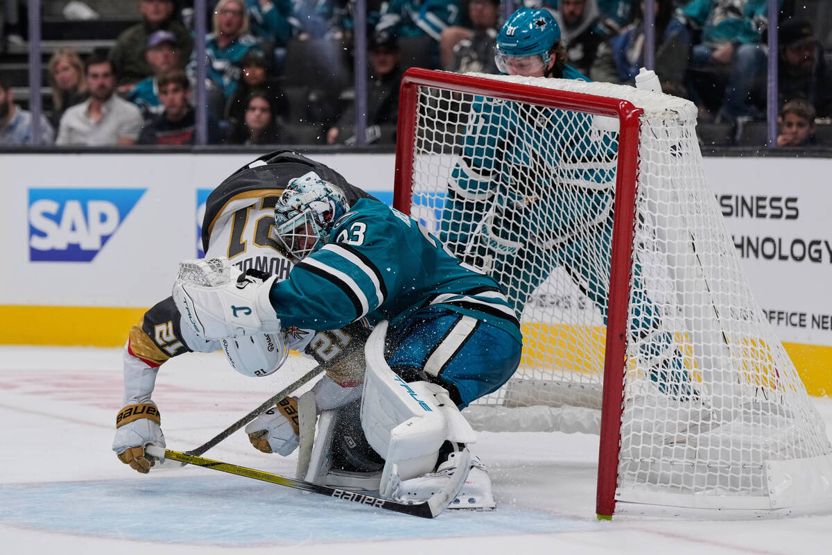 Vegas Golden Knights center Brett Howden (21) collides with San Jose Sharks goaltender Alex Ned ...