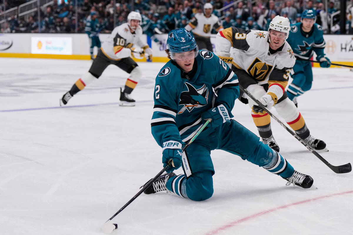 San Jose Sharks center Will Smith (2) moves the puck while being chased by Vegas Golden Knights ...