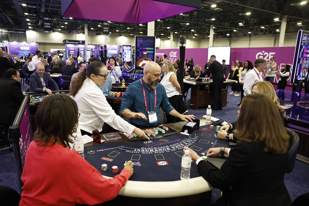 Martin Parra, middle, table games dealer at Talking Stick, competes at the G2E Dealer Champions ...