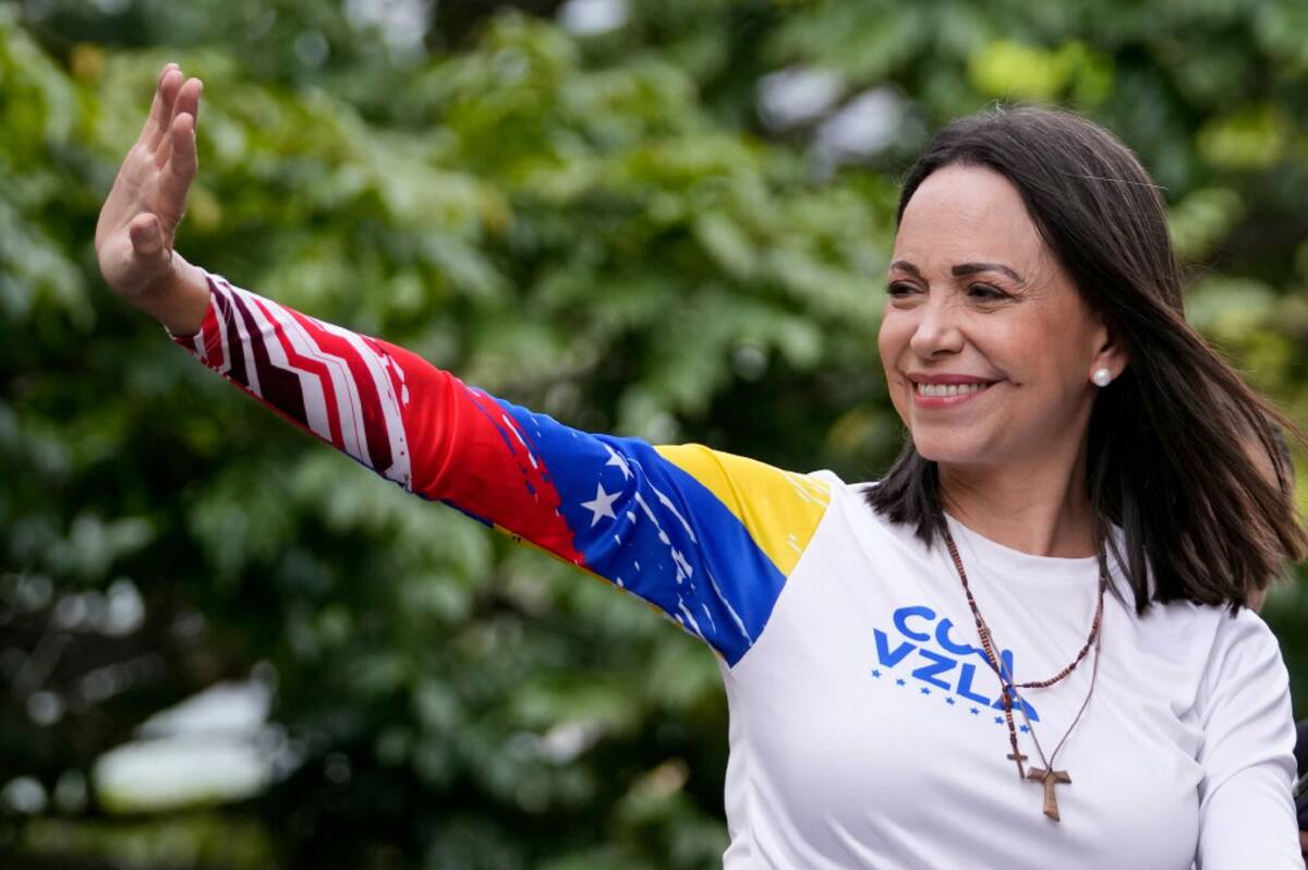 Opposition leader Maria Corina Machado waves from atop a truck during the closing election camp ...
