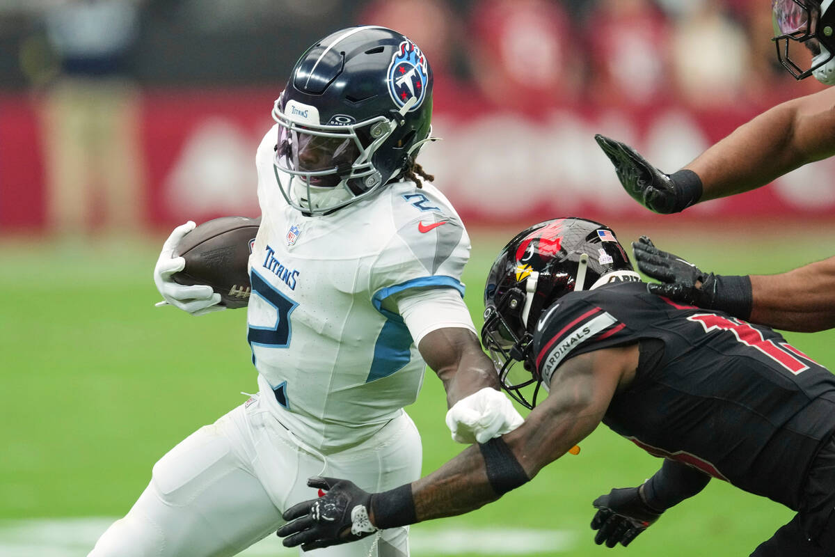 Tennessee Titans running back Tyjae Spears (2) runs the ball past Arizona Cardinals cornerback ...