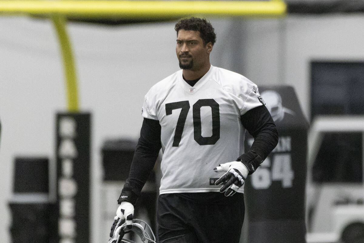 Raiders offensive tackle Stone Forsythe (70) holds his helmet during a team practice at the Int ...