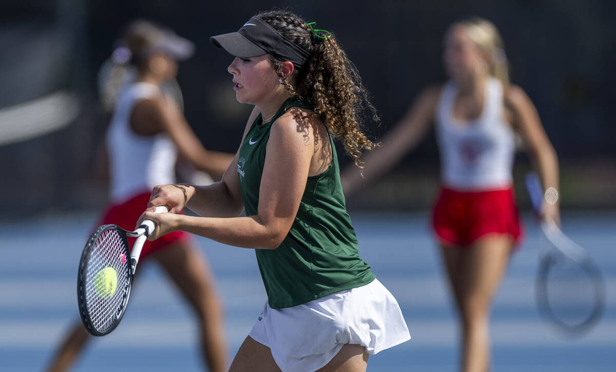 Palo Verde's Tallulah Pinjuv returns the ball to a Coronado player in their singles match ...