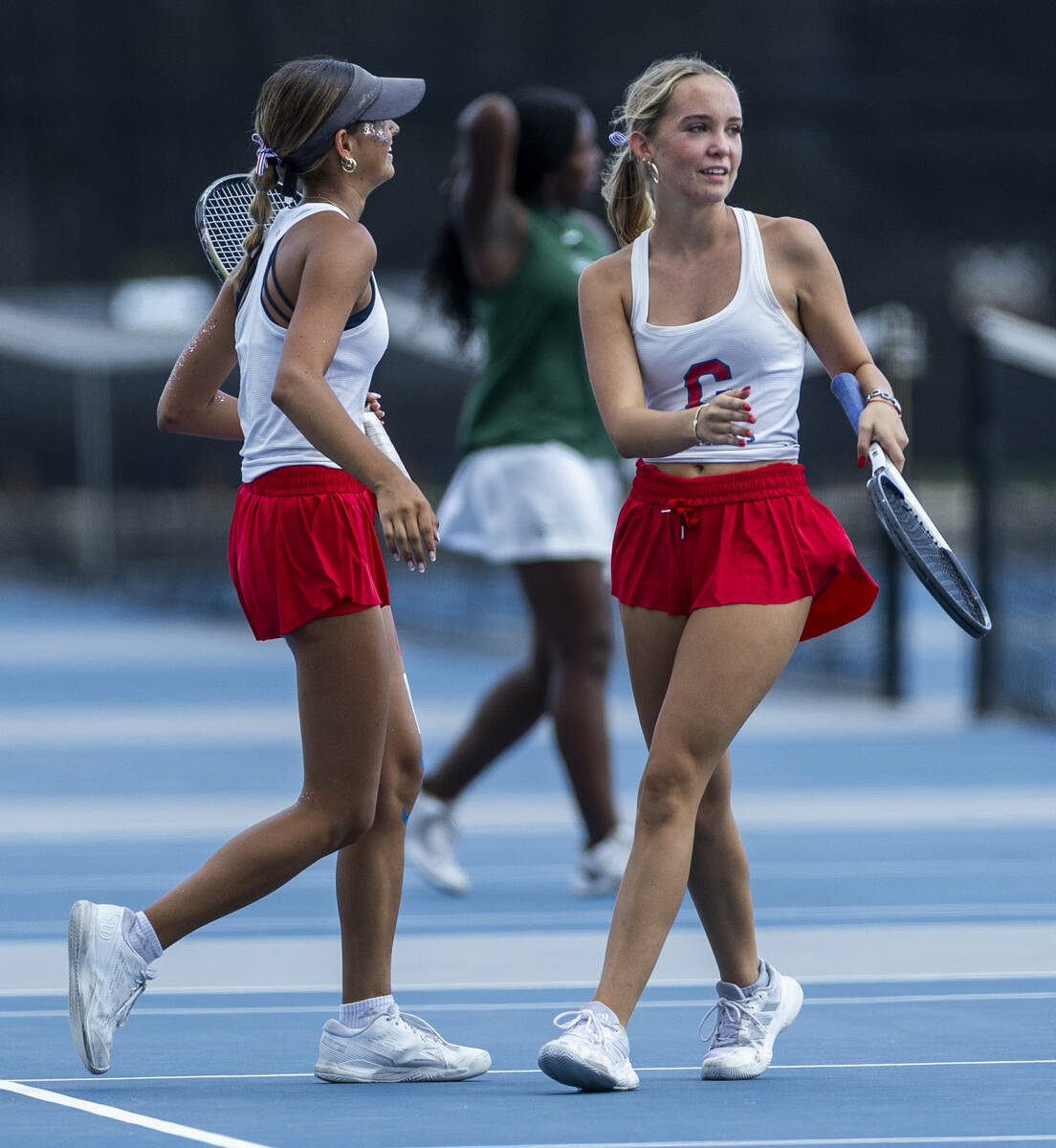 Coronado's Isabella Gallegos and Gigi Smart come together to chat in their doubles match a ...