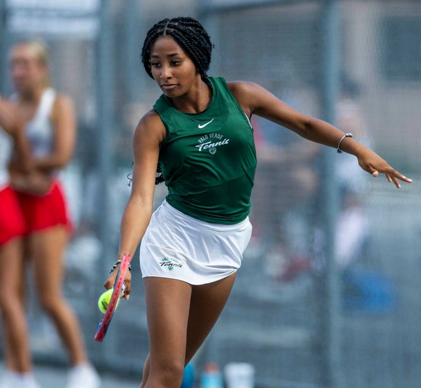 Palo Verde's Nicole Perrin digs out a return to a Coronado player in their singles match d ...