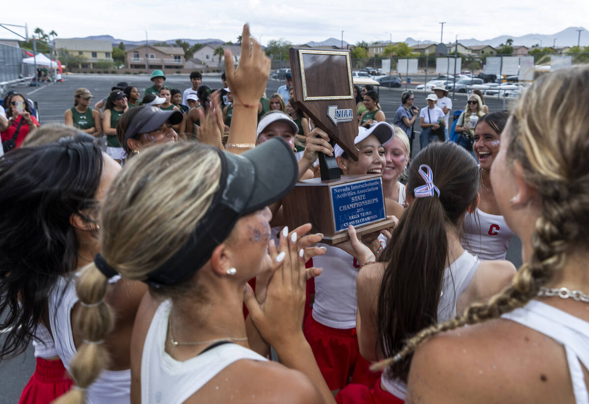 Coronado players celebrate the team victory with their trophy over Palo Verde winning the 5A gi ...