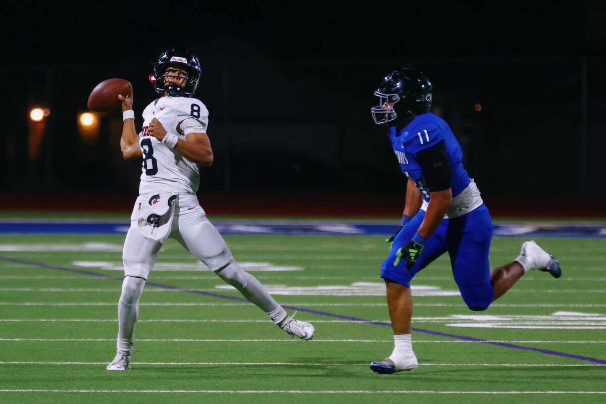 Las Vegas quarterback Tanner Vibabul (8) looks for someone to pass to during a football game on ...