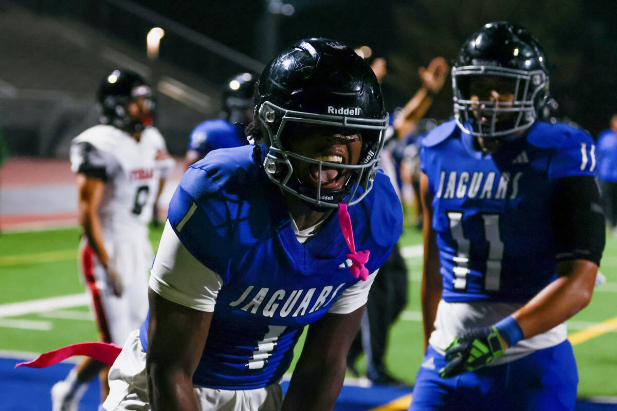 Desert Pines’ Michael Taylor (1) yells as he celebrates a touchdown he made during a foo ...