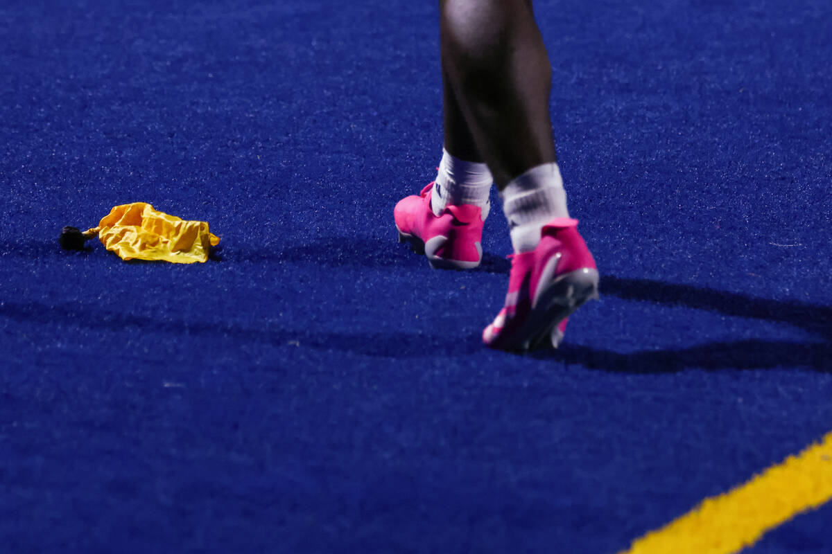 A penalty flag lies at the feet of Desert Pines’ Michael Taylor (1) after he made a touc ...