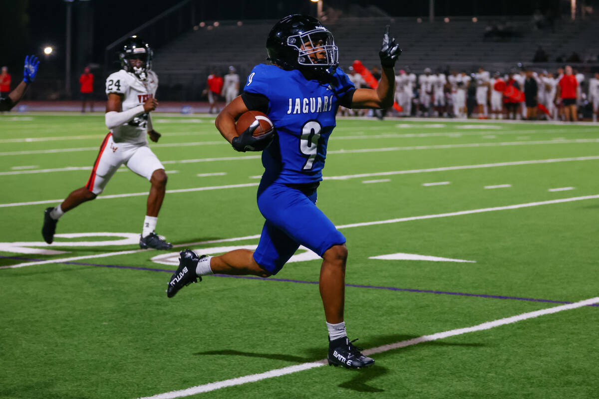 Desert Pines wide receiver Mario Velasco Fletcher (9) puts a finger up as he runs toward the en ...