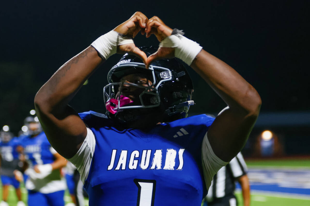 Desert Pines’ Michael Taylor (1) puts up his hands in a heart after making a successful ...