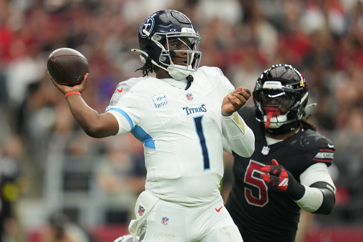 Tennessee Titans quarterback Cam Ward (1) passes the ball against the Arizona Cardinals during ...