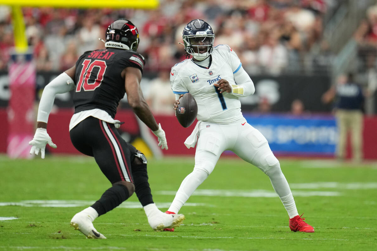 Tennessee Titans quarterback Cam Ward (1) runs the ball against the Arizona Cardinals during th ...