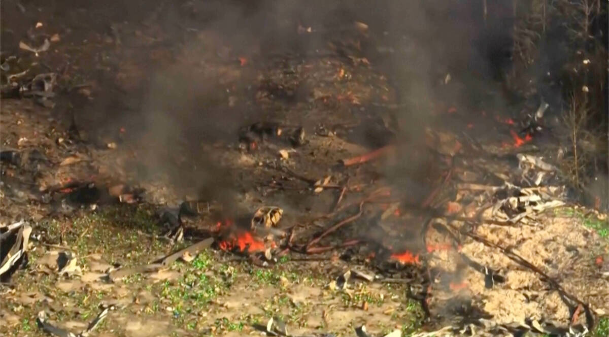 Smoke fills the air as debris covers the ground and vehicles after a powerful blast ripped thro ...