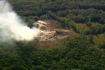Smoke fills the air as debris covers the ground and vehicles after a powerful blast ripped thro ...