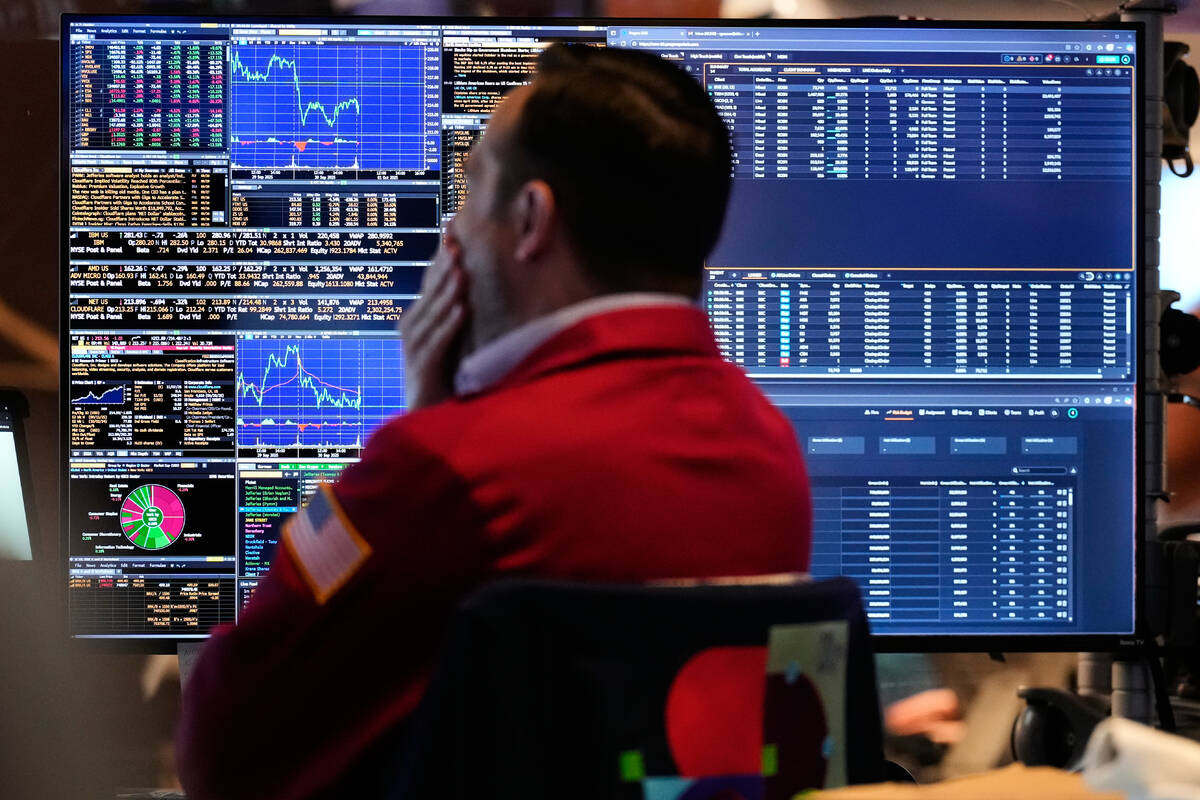 A trader looks at financial information on his computer on the floor at the New York Stock Exch ...